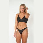 Woman wearing a black bikini on a white background