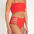 Red bikini set on a plain background